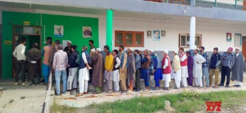 Baramulla: Voters line up at a polling booth during the third phase of Jammu and Kashmir Assembly Elections in Baramulla on Tuesday, October 01, 2024. (Photo: IANS)