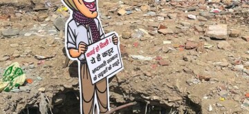 New Delhi: A cut-out of Aam Aadmi Party (AAP) Supremo Arvind Kejriwal is placed at a pothole during a Delhi BJP protest against poor road conditions at Chandni Chowk in New Delhi on Wednesday, October 3, 2024. (Photo: IANS)