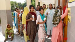 Sonipat: Voters display identity cards while standing in a queue to cast their votes at a polling booth during the Haryana Assembly elections in Sonipat on Saturday, October 05, 2024. (Photo: IANS)