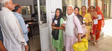 Sonipat: Voters display identity cards while standing in a queue to cast their votes at a polling booth during the Haryana Assembly elections in Sonipat on Saturday, October 05, 2024. (Photo: IANS)