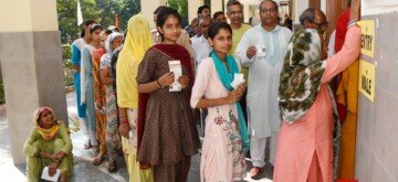 Sonipat: Voters display identity cards while standing in a queue to cast their votes at a polling booth during the Haryana Assembly elections in Sonipat on Saturday, October 05, 2024. (Photo: IANS)