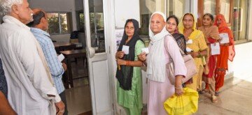 Sonipat: Voters display identity cards while standing in a queue to cast their votes at a polling booth during the Haryana Assembly elections in Sonipat on Saturday, October 05, 2024. (Photo: IANS)