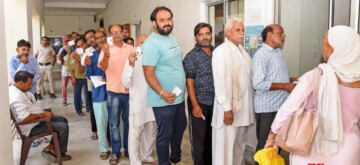 Sonipat: Voters display identity cards while standing in a queue to cast their votes at a polling booth during the Haryana Assembly elections in Sonipat on Saturday, October 05, 2024. (Photo: IANS)