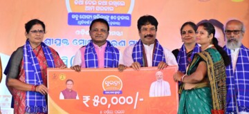 Mayurbhanj: Odisha Chief Minister Mohan Charan Majhi presents a first installment cheque to a beneficiary during the program of 'Subhadra Yojana' at Baripadar, Odisha, on Wednesday, October 09, 2024. (Photo: IANS)