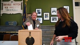 A moderator helps a voter (R) cast her ballot for the U.S. presidential election in Dixville Notch, New Hampshire, the United States, on Nov. 5, 2024. Voters in Dixville Notch, New Hampshire, went to the polls early Tuesday morning, marking the official start of Election Day voting for the 2024 U.S. presidential election. (IANS/Xinhua/Li Rui)