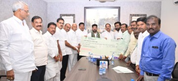 Hyderabad: Telangana Chief Minister Revanth Reddy receives a cheque of rupees 1.51 crore from Telangana State Co-operative Apex Bank Limited (TGCAB) for the Chief Minister's Relief Fund. TGCAB officials hand over the donation at his residence in Hyderabad on Wednesday, November 6, 2024. (Photo: IANS)