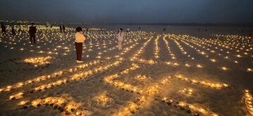 Varanasi: Devotees light earthen lamps (diyas) on the ghats , marking the auspicious occasion of Sharad Purnima and Dev Deepawali in Varanasi on Friday, November 15, 2024. (Photo: IANS)